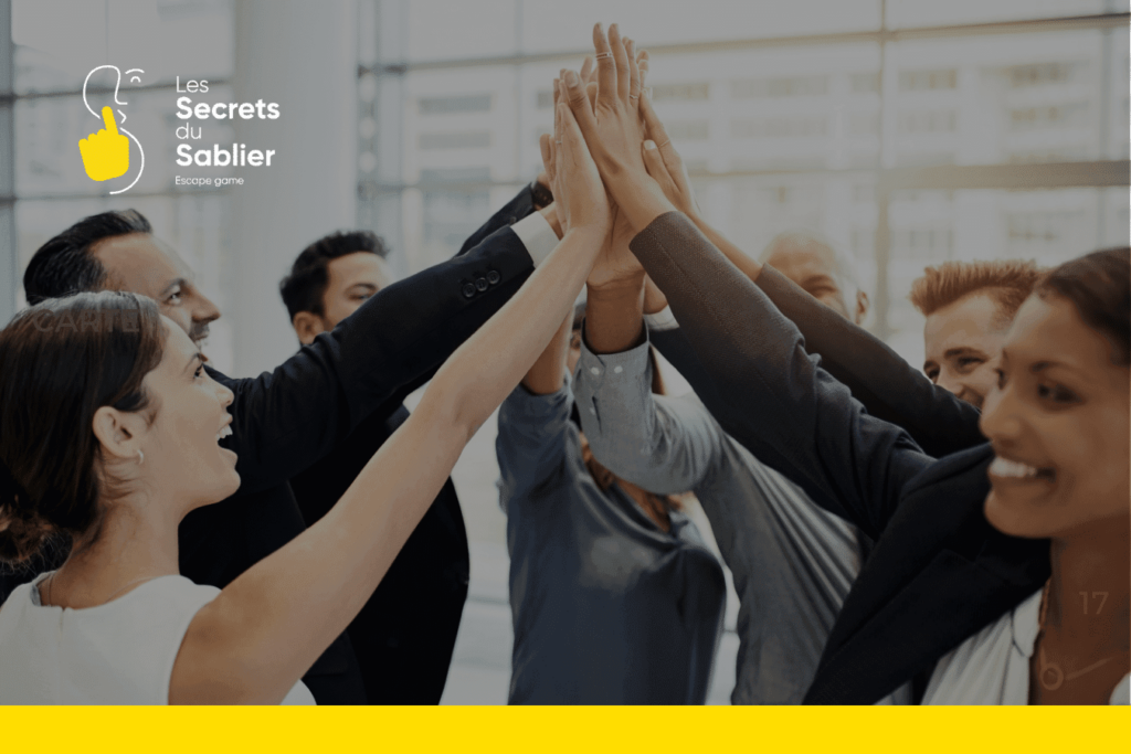 Une journée d’équipe inoubliable chez Les Secrets du Sablier : cohésion et convivialité 4 Journée d'équipe: Un groupe de collègues se donnant un high-five, symbolisant la cohésion et l'esprit d'équipe lors d'un événement de team building chez Les Secrets du Sablier.